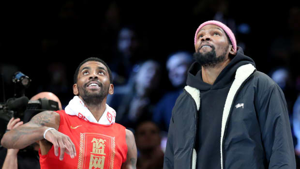 Kyrie Irving and Kevin Durant look up at the Barclays Center.