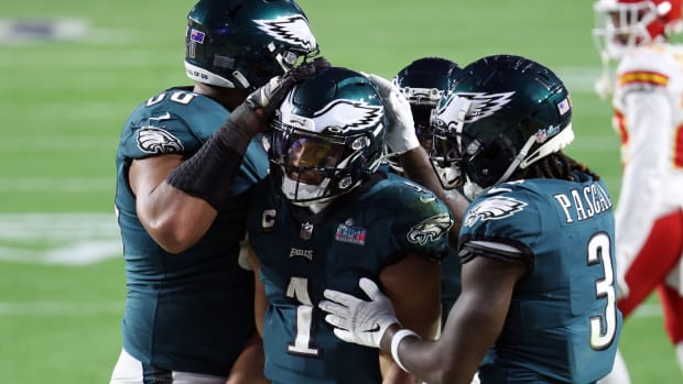 Eagles quarterback Jalen Hurts is congratulated by teammates after scoring a touchdown in the fourth quarter against the Chiefs in Super Bowl LVII.
