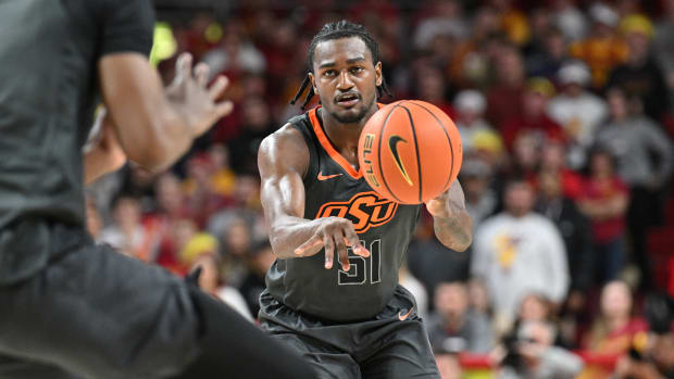 Feb 11, 2023; Ames, Iowa, USA; Oklahoma State Cowboys guard John-Michael Wright (51) controls the ball against the Iowa State Cyclones during the second half at James H. Hilton Coliseum.