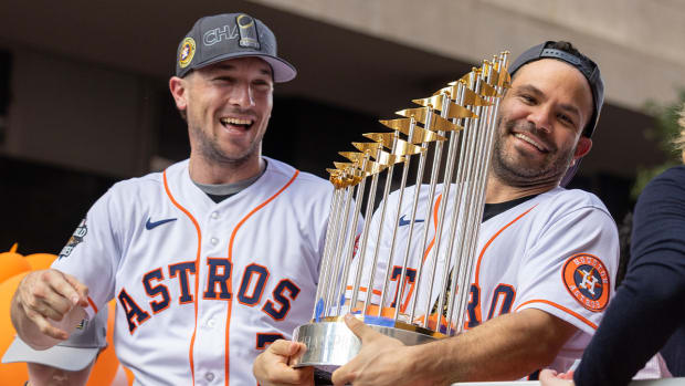 Nov 7, 2022; Houston Astros third baseman Alex Bregman (2) and second baseman Jose Altuve (27) celebrate with the 2022 Commissioner s Trophy in the Houston Astros Championship Parade in Houston, Texas, USA.