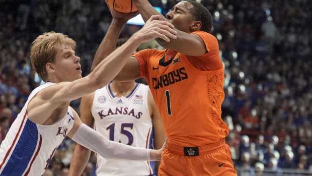 Dec 31, 2022; Lawrence, Kansas, USA; Oklahoma State Cowboys guard Bryce Thompson (1) shoots and is fouled by Kansas Jayhawks guard Gradey Dick (4) during the first half at Allen Fieldhouse. Mandatory Credit: Denny Medley-USA TODAY Sports