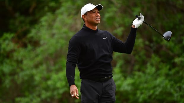 Pacific Palisades, California, USA; Tiger Woods reacts after hitting from the twelfth hole tee during the second round of The Genesis Invitational golf tournament.