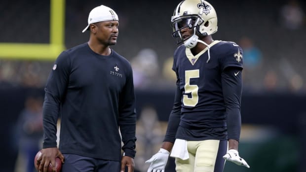 New Orleans Saints quarterback Teddy Bridgewater (5) talks to wide receivers coach Ronald Curry before their game