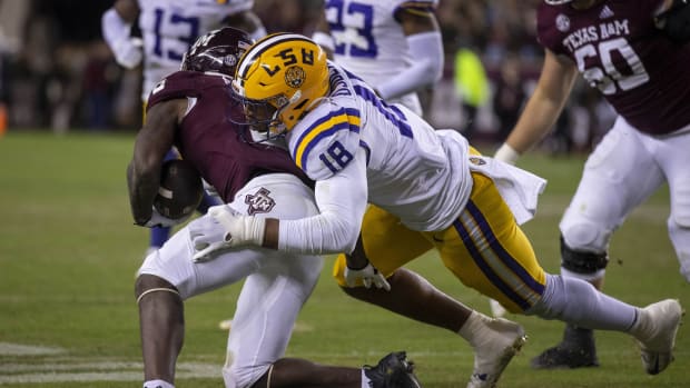 Nov 26, 2022; College Station, Texas, USA; LSU Tigers defensive end BJ Ojulari (18) and Texas A&M Aggies running back Devon Achane (6) in action during the game between the Texas A&M Aggies and the LSU Tigers at Kyle Field. Mandatory Credit: Jerome Miron-USA TODAY Sports