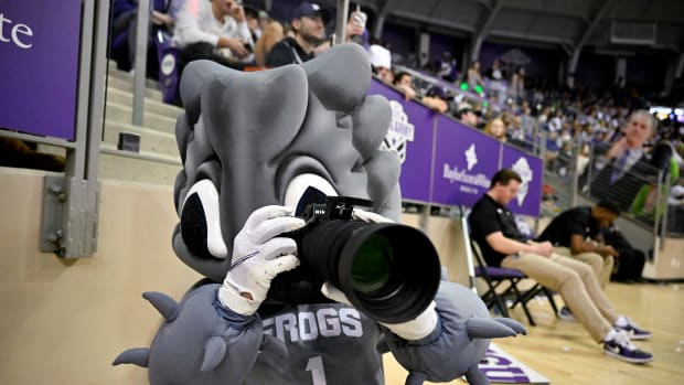 Feb 18, 2023; Fort Worth, Texas, USA; A view of the TCU Horned Frogs mascot taking photos with a photographer s camera during the second half of the game between the Oklahoma State Cowboys and the TCU Horned Frogs at the Ed and Rae Schollmaier Arena.