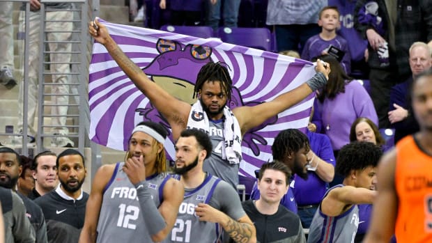 Feb 18, 2023; Fort Worth, Texas, USA; TCU Horned Frogs center Eddie Lampkin Jr. (4) holds up a Hypnotoad flag during the second half of the game between the Oklahoma State Cowboys and the TCU Horned Frogs at the Ed and Rae Schollmaier Arena. Mandatory Credit: Jerome Miron-USA TODAY Sports