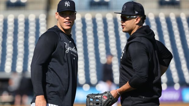 Yankees outfielders Aaron Judge and Giancarlo Stanton talk during a Spring Training practice.