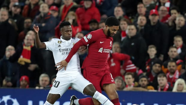 Real Madrid forward Vinicius Junior (left) and Liverpool defender Joe Gomez pictured battling for the ball during a UEFA Champions League last 16 first leg game at Anfield in February 2023