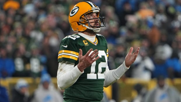 Aaron Rodgers looks up with his hands out in frustration