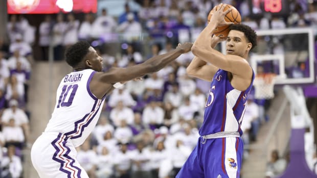 Kansas Jayhawks guard Kevin McCullar Jr. (15) looks to pass as TCU Horned Frogs guard Damion Baugh (10) defends during the second half at Ed and Rae Schollmaier Arena.