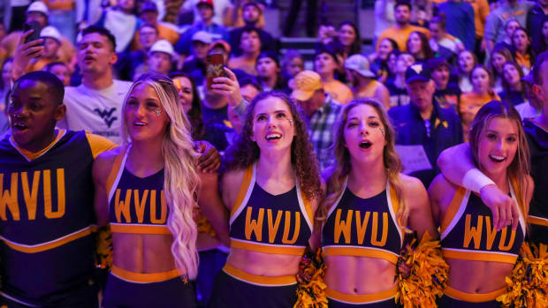 Feb 20, 2023; Morgantown, West Virginia, USA; West Virginia Mountaineers cheerleaders sing \"Country Roads\" after defeating the Oklahoma State Cowboys at WVU Coliseum. Mandatory Credit: Ben Queen-USA TODAY Sports