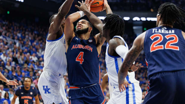 Feb 25, 2023; Lexington, Kentucky, USA; Auburn Tigers forward Johni Broome (4) goes to the basket against Kentucky Wildcats defenders during the first half at Rupp Arena at Central Bank Center. Mandatory Credit: Jordan Prather-USA TODAY Sports