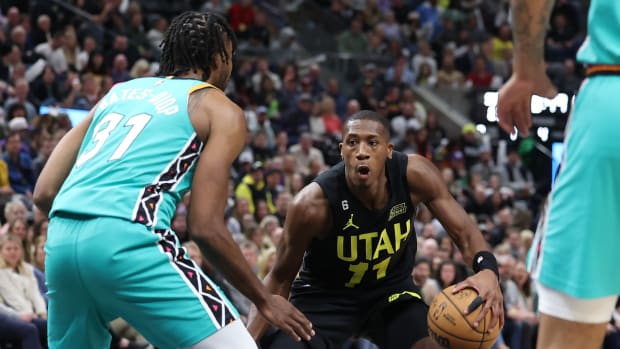 Feb 25, 2023; Salt Lake City, Utah, USA; Utah Jazz guard Kris Dunn (11) controls the ball against San Antonio Spurs forward Keita Bates-Diop (31) in the second half at Vivint Arena.