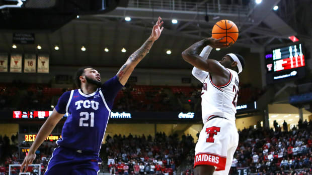 Texas Tech Red Raiders guard De Vion Harmon (23) takes a jump shot over TCU Horned Frogs forward JaKobe Coles (21) in the second half at United Supermarkets Arena