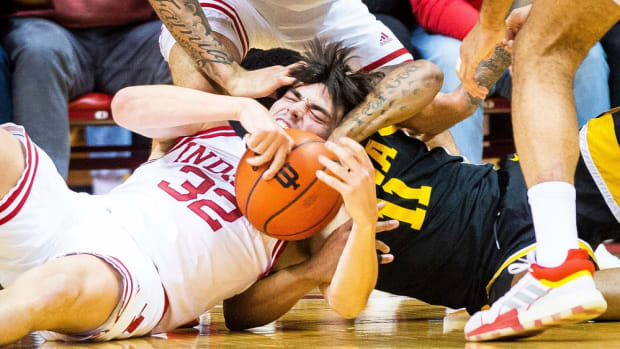 Indiana's Trey Galloway (32) fights with Iowa's Tony Perkins (11) for a loose ball during the first half of the Indiana versus Iowa men's basketball game at Simon Skjodt Assembly Hall.