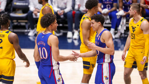 Jan 7, 2023; Morgantown, West Virginia, USA; Kansas Jayhawks guard Kevin McCullar Jr. (15) celebrates with Kansas Jayhawks forward Jalen Wilson (10) after a play during the second half against the West Virginia Mountaineers at WVU Coliseum. Mandatory Credit: Ben Queen-USA TODAY Sports