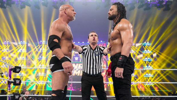 Bill Goldberg and Roman Reigns stand toe-to-toe in the ring