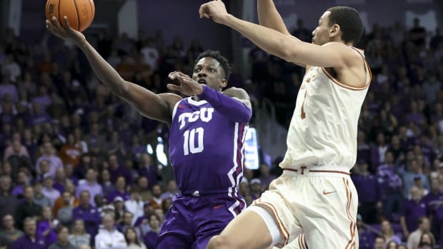 Mar 1, 2023; Fort Worth, Texas, USA; TCU Horned Frogs guard Damion Baugh (10) shoots past Texas Longhorns forward Dylan Disu (1) during the first half at Ed and Rae Schollmaier Arena.