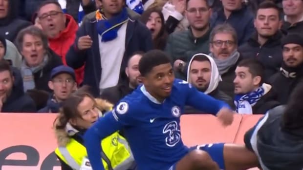 Chelsea defender Wesley Fofana pictured (center) after accidentally knocking over a security steward (left) at Stamford Bridge during an EPL game against Leeds in March 2023