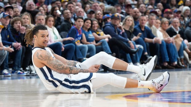 Memphis Grizzlies forward Brandon Clarke holds his leg after he was injured in the first half of an NBA basketball game against the Denver Nuggets, Friday, March 3, 2023, in Denver. (AP Photo/David Zalubowski)