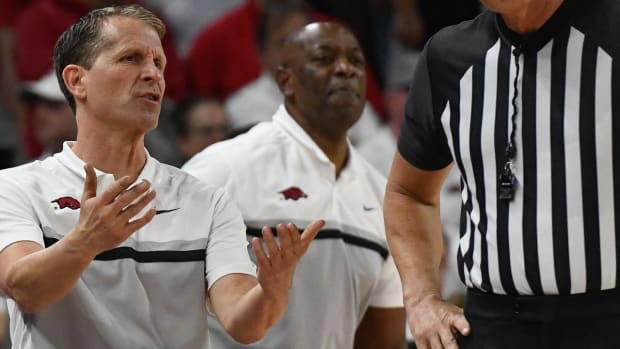 Arkansas Razorbacks coach Eric Musselman argues with SEC official Don Daily during Saturday's game with Kentucky.