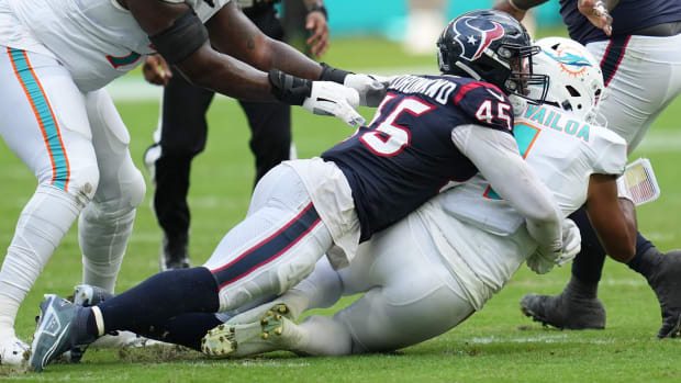 Houston Texans linebacker Ogbonnia Okoronkwo (45) takes down Miami Dolphins quarterback Tua Tagovailoa (1) during the first half of an NFL game at Hard Rock Stadium in Miami Gardens, Nov. 27, 2022.