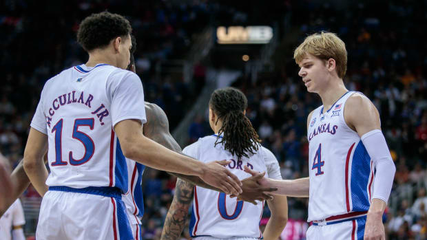 Mar 9, 2023; Kansas City, MO, USA; Kansas Jayhawks guard Kevin McCullar Jr. (15) reacts with Kansas Jayhawks guard Gradey Dick (4) during a break in play during the first half against the West Virginia Mountaineers at T-Mobile Center.