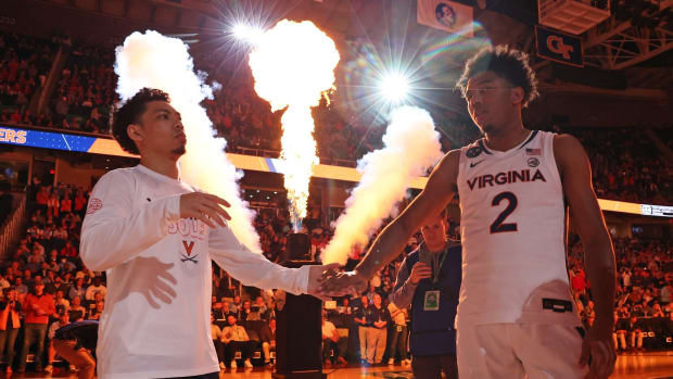 Kihei Clark and Reece Beekman high five during player introductions before the Virginia men's basketball game against North Carolina in the quarterfinals of the ACC Men's Basketball Tournament at Greensboro Coliseum.