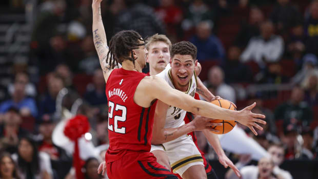 Purdue Boilermakers forward Mason Gillis (0) is defended by Rutgers Scarlet Knights guard Caleb McConnell (22) during the first half at United Center.