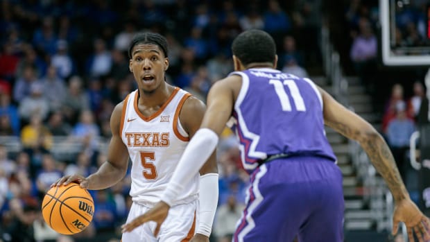 Mar 10, 2023; Kansas City, MO, USA; Texas Longhorns guard Marcus Carr (5) sets the play around TCU Horned Frogs guard Rondel Walker (11) during the first half at T-Mobile Center.