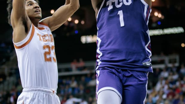 Mar 10, 2023; Kansas City, MO, USA; TCU Horned Frogs guard Mike Miles Jr. (1) puts up a shot around Texas Longhorns forward Dillon Mitchell (23) during the second half at T-Mobile Center.