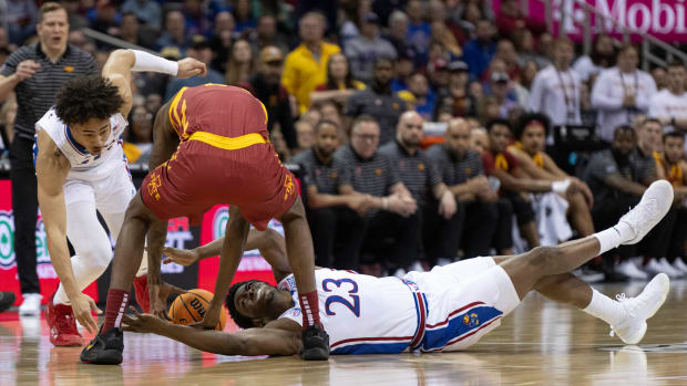 Mar 10, 2023; Kansas City, MO, USA; Iowa State Cyclones forward Hason Ward (24) and Kansas Jayhawks center Ernest Udeh Jr. (23) fight for possession of the ball in the first half at T-Mobile Center. Mandatory Credit: Amy Kontras-USA TODAY Sports