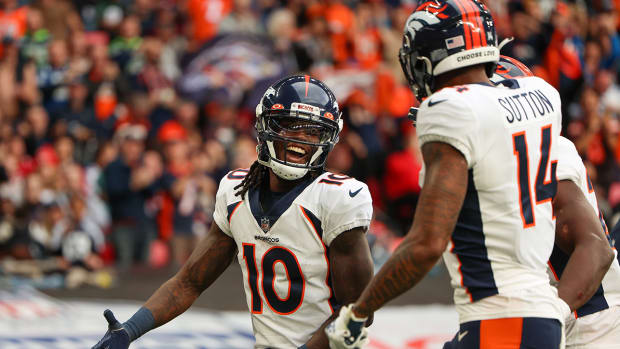 Broncos wide receiver Jerry Jeudy (10) is congratulated by wide receiver Courtland Sutton (14) after scoring a touchdown.