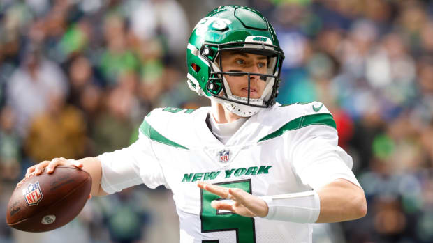 Jets quarterback Mike White looks to throw a pass during a game in 2022.