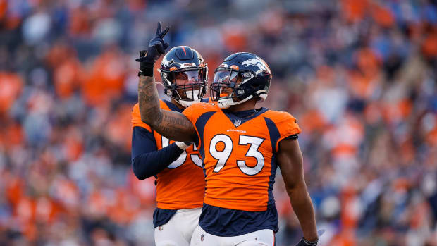Denver Broncos defensive end Dre'Mont Jones (93) celebrates with linebacker Bradley Chubb (55) after a play in the third quarter against the Detroit Lions at Empower Field at Mile High.
