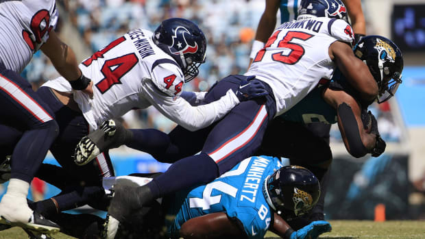 Jacksonville Jaguars running back James Robinson (25) is tackled by Houston Texans linebacker Ogbonnia Okoronkwo (45) during the first quarter of an NFL football game Sunday, Oct. 9, 2022 at TIAA Bank Field in Jacksonville. The Texans won 13-6. [Corey Perrine/Florida Times-Union] Jki 100822 Texans Jags Cp 58