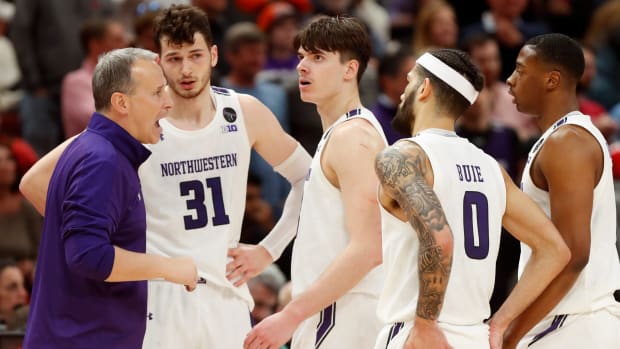 Northwestern basketball coach Chris Collins talks to his players during the Big Ten men’s basketball tournament game against Penn State.