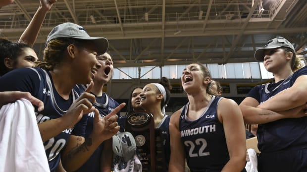 Mar 12, 2023; Towson, MD, USA; Monmouth Hawks celebrate on the court after defeating the Towson Tigers in the CAA Tournament Championship at SECU Arena.
