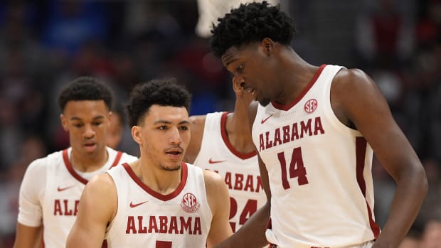 Alabama Crimson Tide guard Jahvon Quinerly (5) and center Charles Bediako (14) celebrate the win against the Texas A&M Aggies during the second half at Bridgestone Arena.