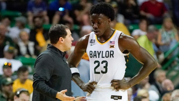 Mar 4, 2023; Waco, Texas, USA; Baylor Bears head coach Scott Drew talks with forward Jonathan Tchamwa Tchatchoua (23) during a time out against the Iowa State Cyclones in the second half at Ferrell Center.