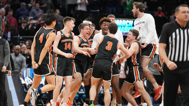 Princeton men's basketball players celebrate after beating Arizona