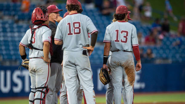 Alabama Crimson Tide pitching coach Jason Jackson talks with his team as they change the pitcher on the final out of the gameduring the SEC baseball tournament at Hoover Metropolitan Stadium in Hoover, Ala., on Wednesday, May 25, 2022.