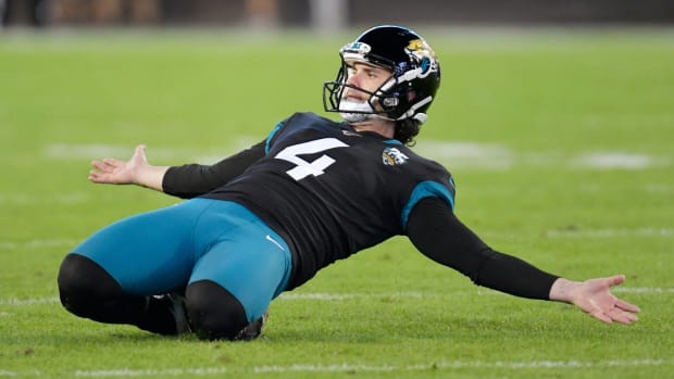 Jaguars kicker Josh Lambo celebrates making a field goal by sliding on the field during a game.