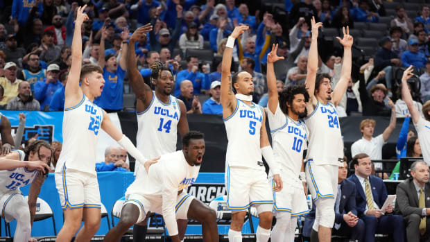 The UCLA Bruins bench celebrates during the second half of a game against UNC Asheville.