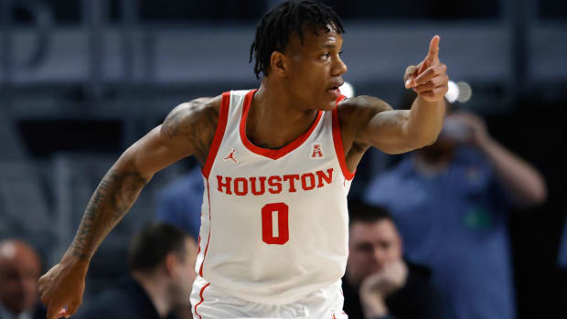 Houston guard Marcus Sasser (0) reacts after scoring a three point basket against East Carolina during the second half of an NCAA college basketball game in the quarterfinals of the American Athletic Conference Tournament, Friday, March 10, 2023, in Fort Worth, Texas. Houston won 60-46. (AP Photo/Ron Jenkins)