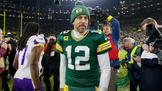 Aaron Rodgers walks around the field after a game against the Vikings.
