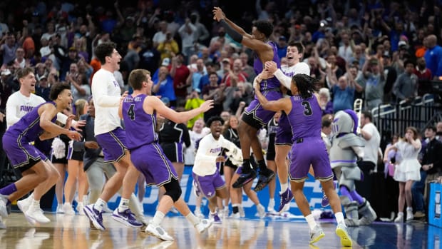 Furman guard JP Pegues, third from right, celebrates with the team after defeating Virginia in a first-round college basketball game in the NCAA Tournament Thursday, March 16, 2023, in Orlando, Fla. (AP Photo/Chris O’Meara)