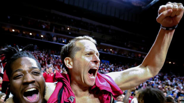 Hogs' Eric Musselman celebrates without his shirt after 72-71 win over Kansas in NCAA Tournament.