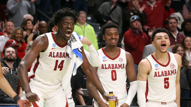 Mar 18, 2023; Birmingham, AL, USA; Alabama center Charles Bediako (14) reacts to a basket by substitute Alabama guard Delaney Heard (12) at Legacy Arena during the second round of the NCAA Tournament. Alabama advanced to the Sweet Sixteen with a 73-51 win over Maryland.