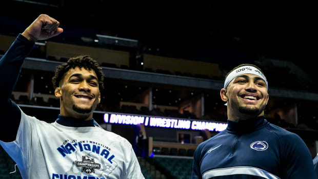 Penn State wrestlers Carter Starocci, left, and Aaron Brooks celebrate winning individual and team titles at the NCAA Wrestling Championships.